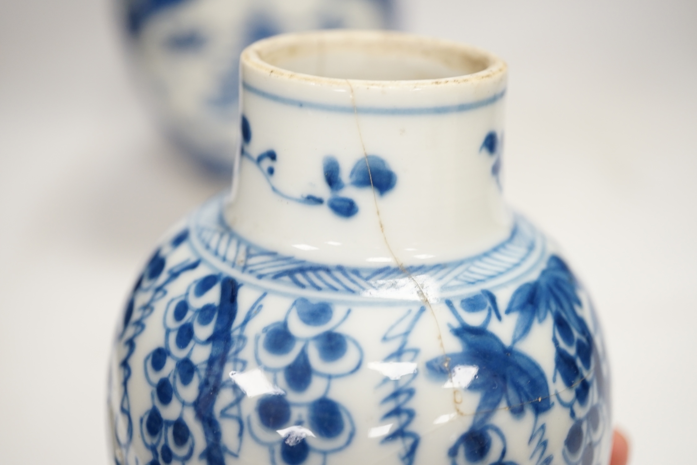 A Chinese Kangxi blue and white jar and a similar vase, jar 19.5cm high. Condition - both cracked and chipped, poor